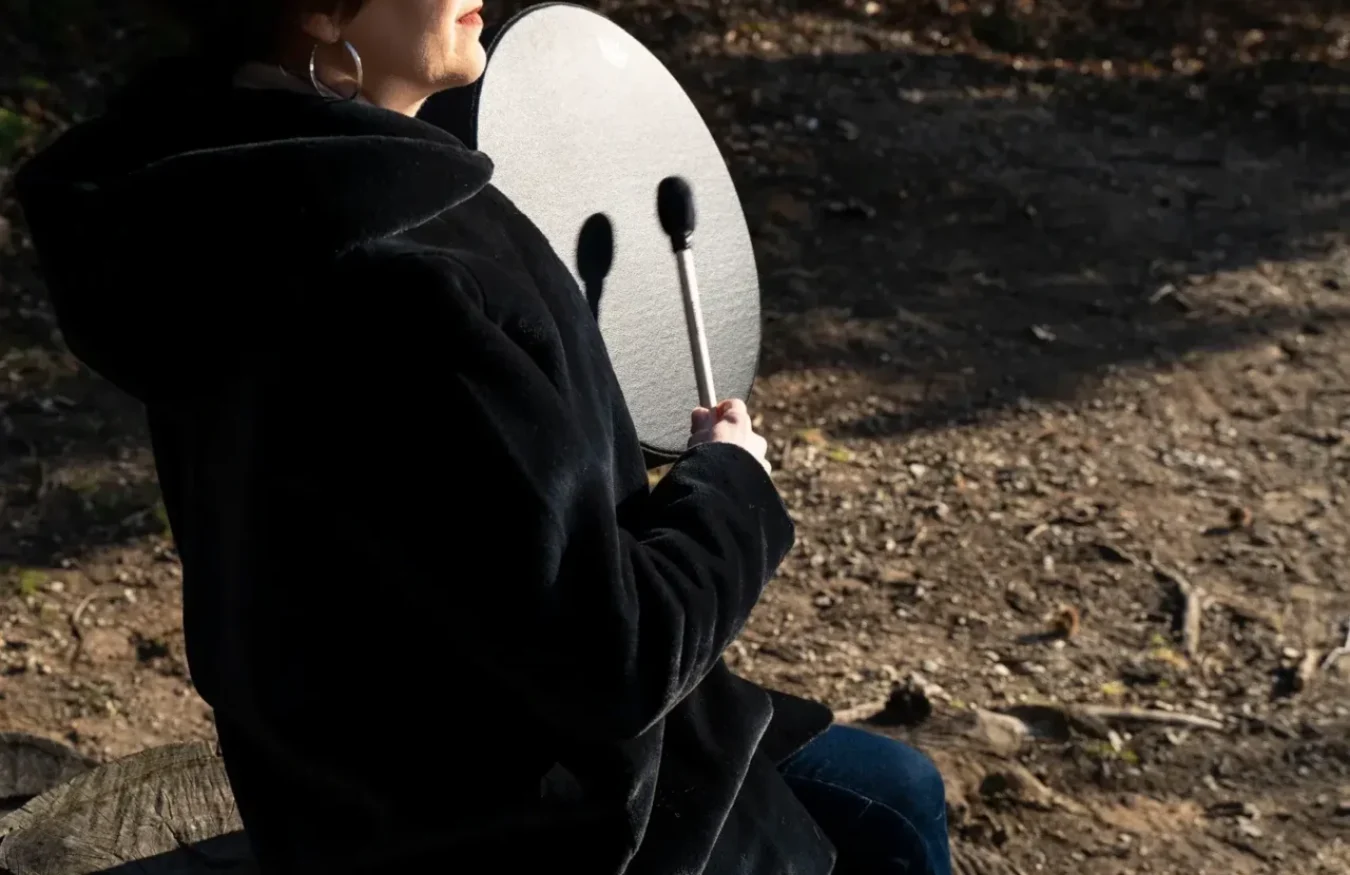 Playing drum at lake eyes closed